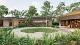 The circular patio connects all of the residence's zones (living, intimate and terrace). Surrounded by vegetation, the architecture emerges from the landscape joined by a curved roof that continues seamlessly throughout the different volumes.