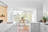 Kitchen, White Cabinet, Engineered Quartz Counter, Medium Hardwood Floor, and Ceiling Lighting  Photo 3 of 23 in Portsea Residence by Construct Melbourne