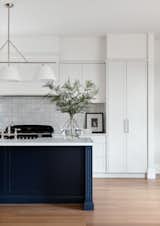 Kitchen at The Grove has built-in bar for a seamless transition from the kitchen to dining space for entertaining with friends.