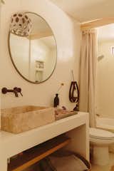 The bathroom features vintage Moroccan tile slab and assorted ceramics.