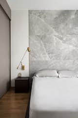 Soft stone and brass trim in the bedroom
