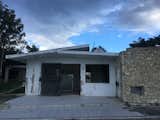 BEFORE:  Back of house, from the pool, with iconic coral stone walls and concrete walls and roof, with huge openings to be solved for hurricanes.