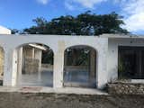 BEFORE: From the driveway, the round arches would be squared and fenced.  The "standard issue" white glazed tile beyond were jackhammered out by the author to reveal terrazzo throughout.