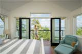 Bedroom, Wall Lighting, Bench, Chair, Night Stands, Ceiling Lighting, Light Hardwood Floor, Rug Floor, Lamps, and Bed Master Bedroom Vista  Photo 12 of 17 in Lakeview Residence by Wang Architects