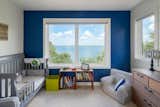 Kids Room, Lamps, Bedroom Room Type, Night Stands, Shelves, Carpet Floor, Dresser, Toddler Age, Neutral Gender, Storage, Boy Gender, Chair, Bookcase, Bed, and Girl Gender Nursery  Photo 14 of 17 in Lakeview Residence by Wang Architects