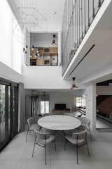 A void in the floor is created at the dining area for connectivity between spaces and bringing in more natural light 