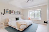 Primary bedroom features a window seat and vaulted ceilings