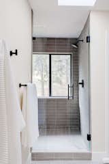 Ensuite primary bathroom features a sky light and wet room with shower and free-standing tub