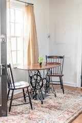 The dining area includes a re-purposed old sewing machine table and antique Hitchcock chairs