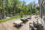 Outdoor, Grass, Walkways, Flowers, Shrubs, Trees, Large Patio, Porch, Deck, Wood Patio, Porch, Deck, Boulders, Side Yard, and Decking Patio, Porch, Deck Outdoor lounging area with gas fireplace   Photo 11 of 12 in Eden House by Susan Seath