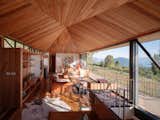 Living, Sofa, Medium Hardwood, Chair, Wall, Storage, Rug, Shelves, Table, and Coffee Tables  Living Sofa Medium Hardwood Wall Shelves Photos from There’s a View From Every Room of This Perched Chilean Cabin