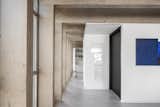 Hallway and Concrete Floor  Photo 18 of 26 in Rhythmic Ceiling Arches Provide Support—and Eye Candy—at This Renovated Apartment in Brazil