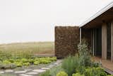 Gabion Walls Made of Volcanic Rock Flank a Flat-Roofed Farmhouse in Australia - Photo 5 of 28 - 