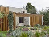 Uncovered Rafters Bridge This Australian Home With Its Lushly Landscaped Yard