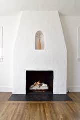 The living room’s original altar-topped fireplace and Sante Fe-style plaster were easy sells for Mandy, who made sure they were preserved during the renovation. 