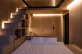 Bedroom, Shelves, Ceiling Lighting, Bed, Track Lighting, Recessed Lighting, Wall Lighting, and Storage  Photo 12 of 16 in Gravity’s No Match for This Cantilevered Cabin in Estonia