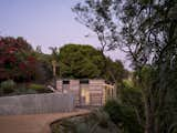 The curved concrete retaining wall slowly reveals the Cover, a design detail the couple love for its thoughtfulness.