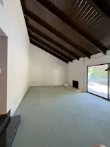 Before: The couple were instant fans of the home’s vaulted wood beamed ceilings.