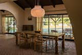 The dining room features a custom table surrounded by chairs from En Gold.