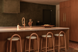 The kitchen island, which is from Reform, is accented with custom bar stools.