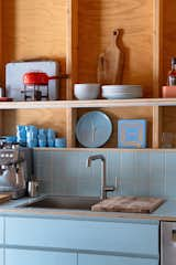 Inspired by William Turnbull Jr.’s Hines House at Sea Reach, the wall framing in the kitchen doubles as shelving.