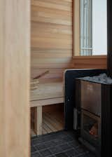 A hardwood window seat next to the wood-fired sauna rounds out the design.&nbsp;