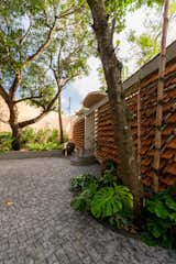 Recycled Roof Shingles Become a Textured Fence For a Curved Home in India - Photo 2 of 15 - 