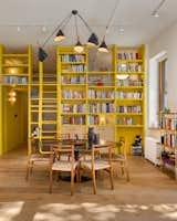 A Yellow Floor-to-Ceiling Library Wall Brightens Up This SoHo Loft