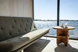 The houseboat has aluminum-framed floor-to-ceiling windows.