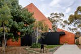 Terra-Cotta Shingles Cover a Multigenerational Home in Melbourne