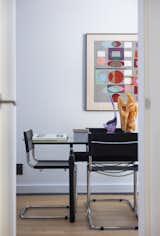 A print by Yaagav Agam overlooks the dining room table