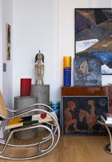 The living room includes two small paintings by Michel Erussard, a large painting by George Mullen, artglass  by Venini, and a vintage chair.
