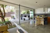 Two sets of folding glass doors remove the barrier between the indoor living space and the outdoor courtyard.