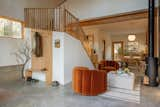 The open-concept living area, a benefit of the Quonset-design, includes velvet chairs from CB2.