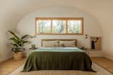 The lofted bedroom is bookended by windows overlooking Ponderosa pines