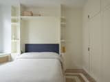 In the guest bedroom, a Murphy bed from Resource Furniture is surrounded by custom cabinetry by Black Square Builders.