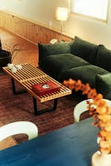 In the living area, a green sofa from Amazon, purchased for around $300, has become a surprise favorite among visiting guests. 