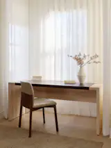 A desk from Croft House and a chair from Design Within Reach complement whitewashed oak floors.