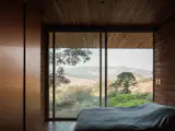 A wall of windows overlook landscape views.