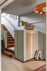 The project began with a request for a custom rug that incorporated years of collected textiles from various travels. The final product, designed by Studio AHEAD, and cut and surged by Floortex Design, is now featured on the foyer staircase.