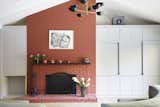 The fireplace is one of the few, if not the only, original features preserved in the renovation. Gallacher painted it a brick red that complements the kitchen’s blue and yellow color palette.