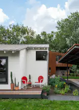 The adaptive reuse of this 1938 East Austin home creates two contemporary structures designed to accommodate three generations of family on a single lot. The street-facing primary home features a preserved facade that blends with the historic neighborhood, while the new rear structure is a distinctly contemporary addition with a Corten-steel envelope.