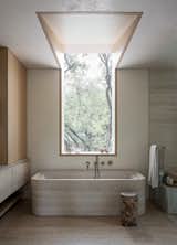 This 4,000-square-foot home is imagined as a quiet retreat tucked into a hillside. The lower level is carved into the natural slope, a gesture that blends the architecture into the landscape and preserves the surrounding canopy. The upper floor extends into the treetops, completing the luminous, calm environment akin to a modern terrarium—without sacrificing privacy.