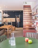 A pair of PH5 lamps by Louis Poulsen hang over a custom wood dining table.