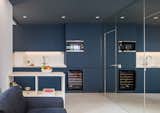 Pardo used dark blue cabinetry and a matching painted ceiling to create a deliberately cave-like kitchen.