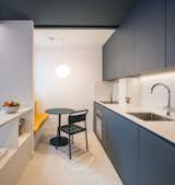 Philippe’s favorite spot in the renovated apartment is the kitchen nook, where a dark green table by Muuto and a built-in banquette upholstered in yellow fabric create a cozy spot for working, eating, and reading.