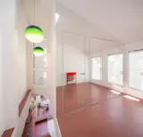 On sunny days, new skylights and clear sightlines flood the second floor with light. At night, a striped green pendant light by Marset illuminates the compact space. 