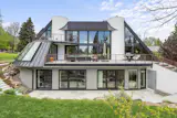 The renovation introduced new solar panels, an electric vehicle charging system, and in-floor radiant heating. 