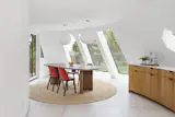 HMH Architecture + Interiors added a dining room by extending the curve of the north tower. 