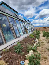 The slanted glass windows support the home’s interior garden.&nbsp;